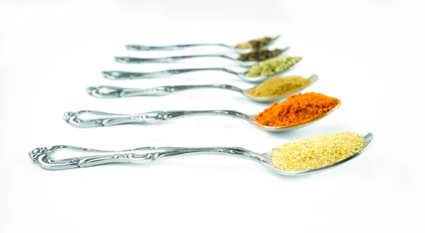 Spices in spoons — Stock Photo, Image