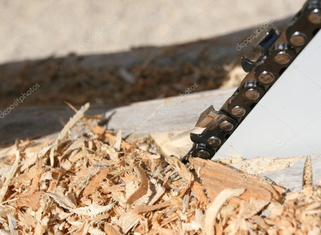 Wood shavings and chainsaw Stock Photo by ©budabar 37236085