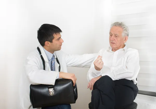 Senior man with doctor Stock Image