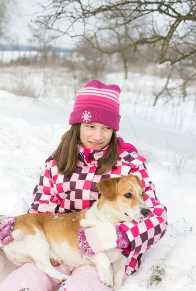 Girl and dog on snow Royalty Free Stock Photos