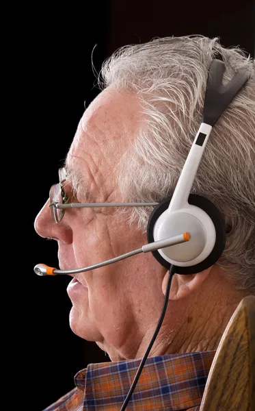 Old man with headset — Stock Photo, Image