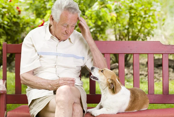 Senior man with his dog — Stock Photo, Image