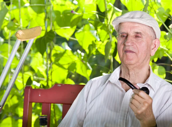 Old man with smoking pipe — Stock Photo, Image