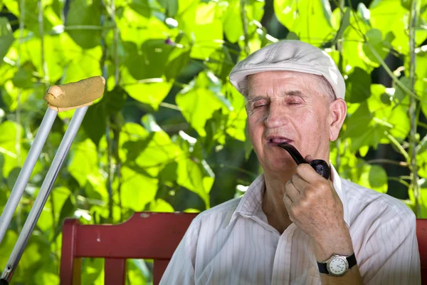 Old man with smoking pipe — Stock Photo, Image