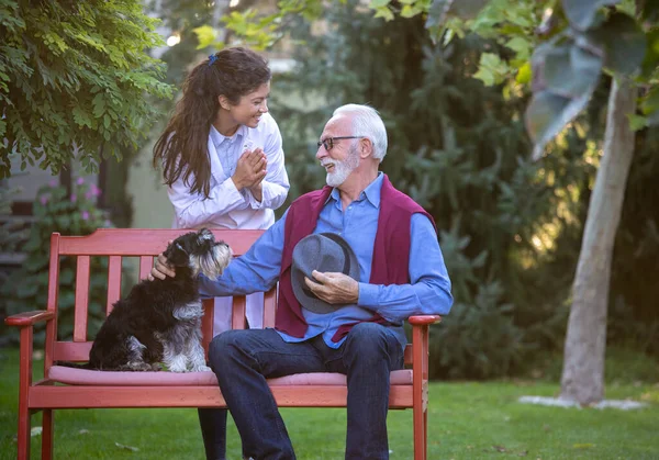 Hombre Edad Avanzada Con Perro Sentado Parque Mientras Que Enfermera — Foto de Stock