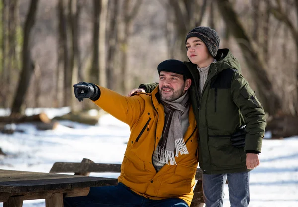 Father Son Sitting Bench Forest Snow Winter Holidays Looking Ahead — Foto de Stock