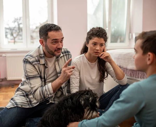 Angry Parents Having Serious Talk Boy His Room Sitting Floor — Zdjęcie stockowe