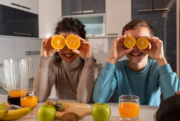 Mother Son Playing Kitchen Preparing Juice Holding Orange Slices Eyes — Fotografia de Stock