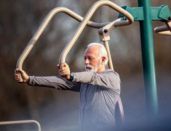 Senior Man Tracksuit Exercising Public Gym Outdoor Spring Time — Stock Photo, Image