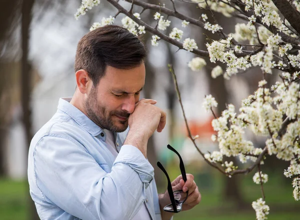 Young Man Having Alergy Symptoms Blooming Tree Spring Time — Stockfoto