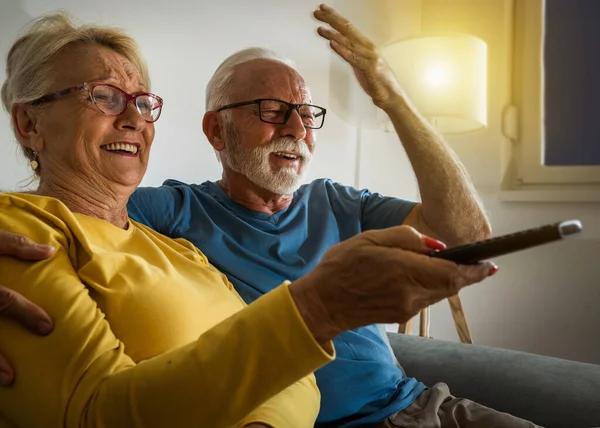 Happy Senior Couple Sitting Sofa Home Watching Laughing — Photo
