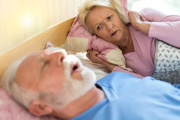 Senior Man Sleeping Back Bed Snoring While Woman Awake Annoyed — Fotografia de Stock