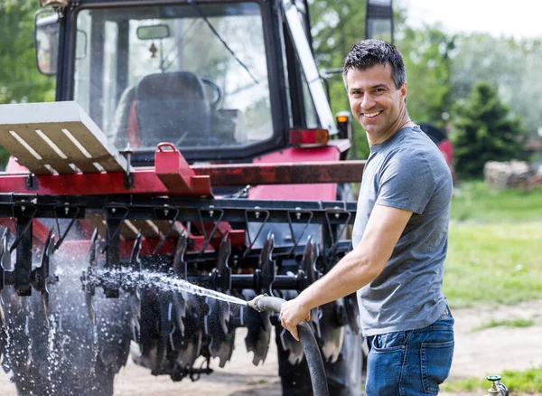 Handsome Satisfied Man Cleaning Tractor Equipment Water Stream Hose Showing — Stock Photo, Image
