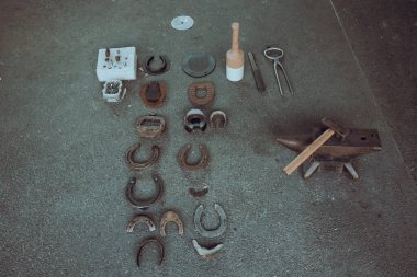 Top view of horse shoes and tools for forging, traditional craft