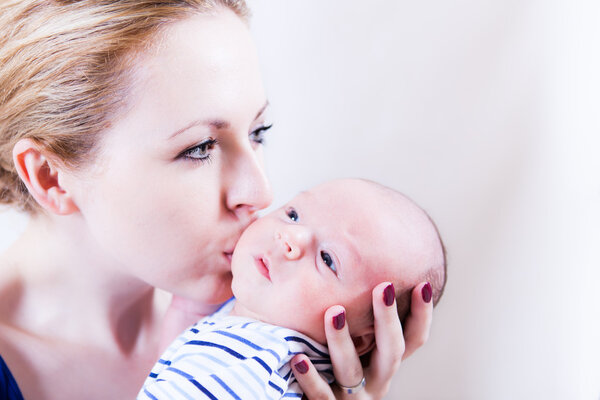 Mother is kissing her son