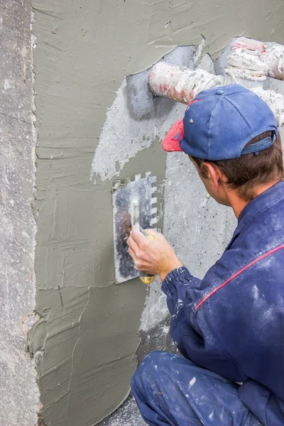 Muratore diffusione malta sul muro di cemento 4 — Foto Stock