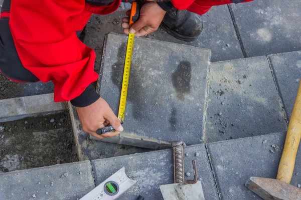 Measure and marking pavement stone before cutting — Stock Photo, Image