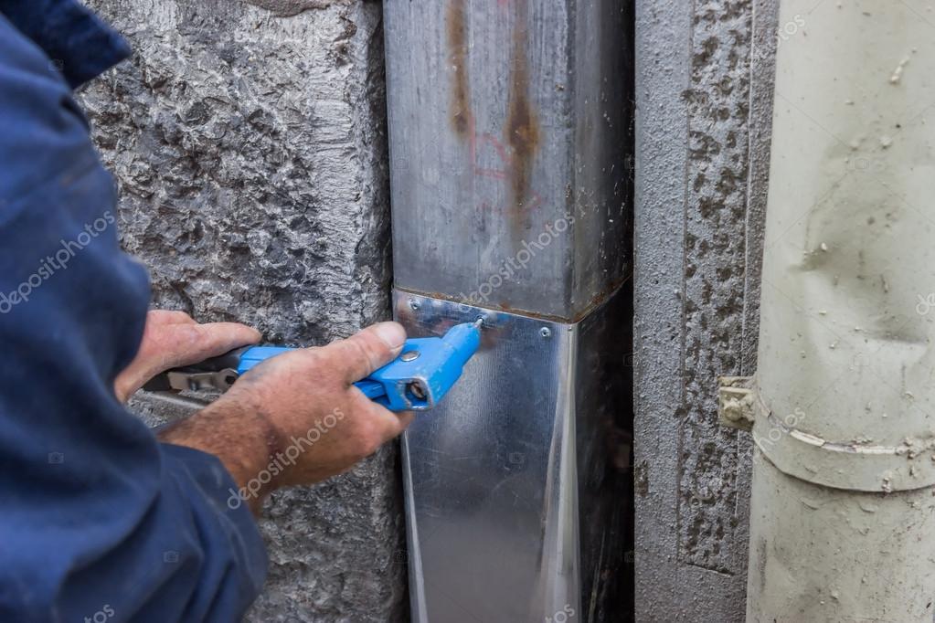 Fixing a leaky gutter downspout 2 Stock Photo by ©kataklinger 36060671