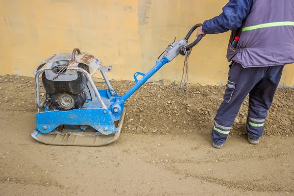 Worker with vibrating plate compactor machine 3 — Stock Photo, Image