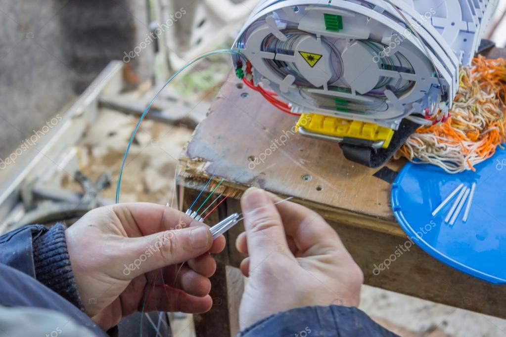 Fibre optic technician preparing fibres for splicing 2 Stock Photo by
