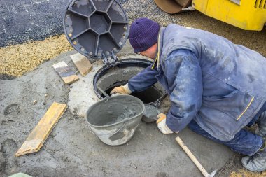 Manhole cover replacement, street reconstruction and improvement clipart