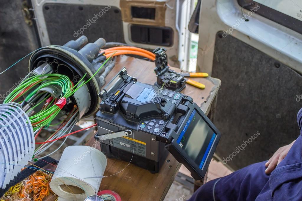 Optic technician splicing fibers Stock Photo by ©kataklinger 38003331