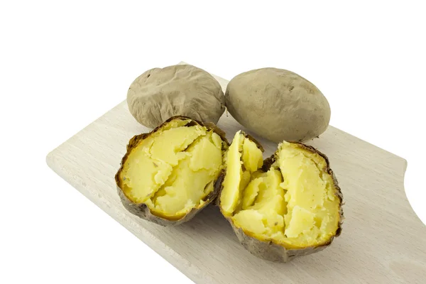 Potatoes from the oven, baked potatoes on cutting board — Stock Photo, Image