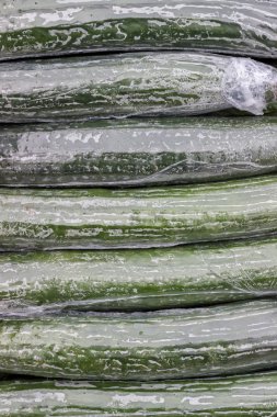 Cucumbers Wrapped in Plastic Background clipart