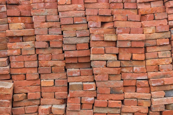 Large pile of red bricks background — Stock Photo, Image