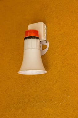 Fire alarm emergency siren on wall clipart