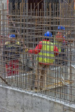 Workers constructing a rebar cage 2 clipart