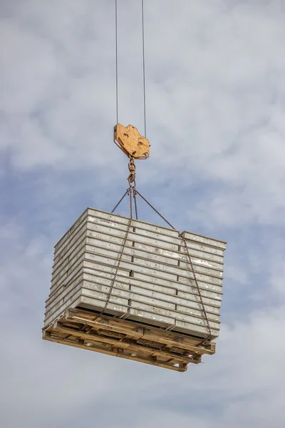 Lifting pallet with formwork elements by crane 2 — Stock Photo, Image