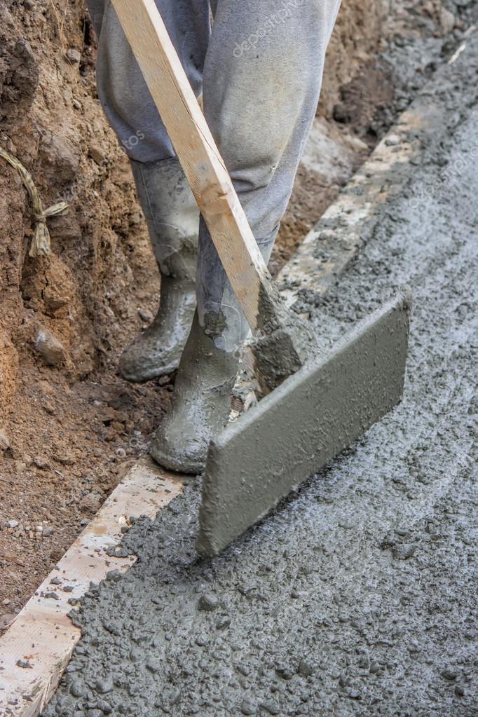 Men wearing rubber boots submerged in poured concrete — Stock Photo © kataklinger 49250327