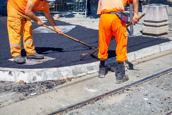 Kroppsarbete Reparation Vägar Vägbyggnadsarbetare Som Jämnar Asfaltbeläggningen — Stockfoto