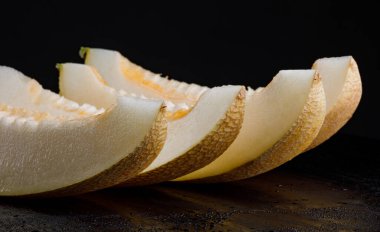 A row of ripe juicy melon lobes.