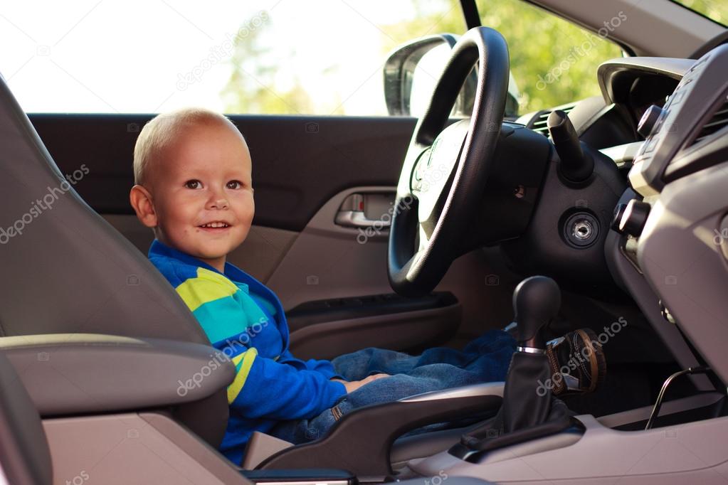 Adorable baby boy in a car