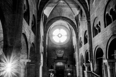 rose window and reflections in the brick cathedral beams of light and shadows reflect on who we are