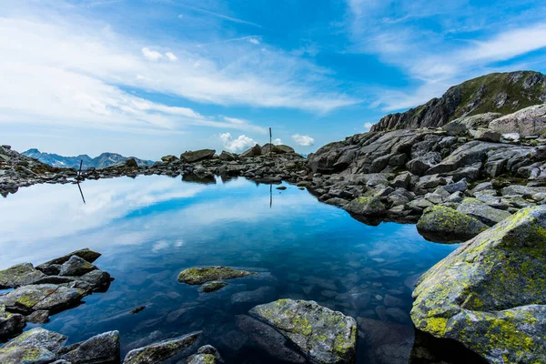 ラゴライ山脈の峰と花崗岩と青い水の間の高山湖トレントイタリアの州のラゴライチェーンのCima Asta近くの透明な水に反映された山の峰 — ストック写真