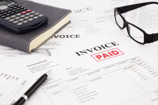 Invoice and bills with paid stamp — Stock Photo, Image