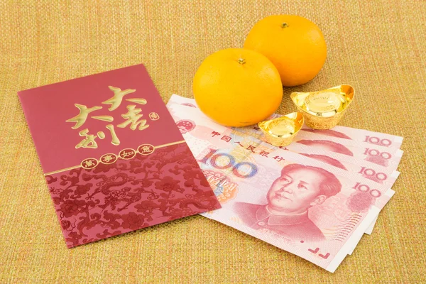 Chinese new year with money yuan banknote and ingot — Stock Photo, Image