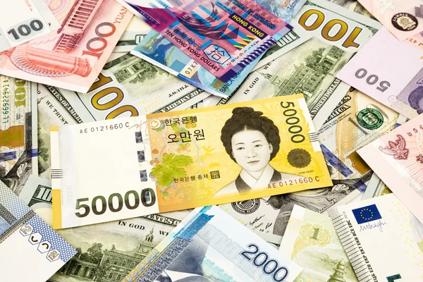 Korejština a světové měny peníze bankovek — Stock fotografie