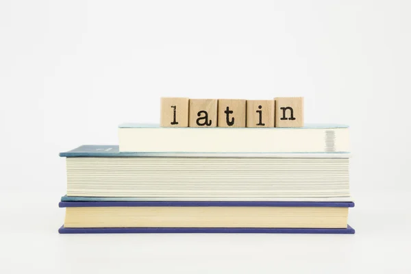 Latin language word on wood stamps and books — Stock Photo, Image