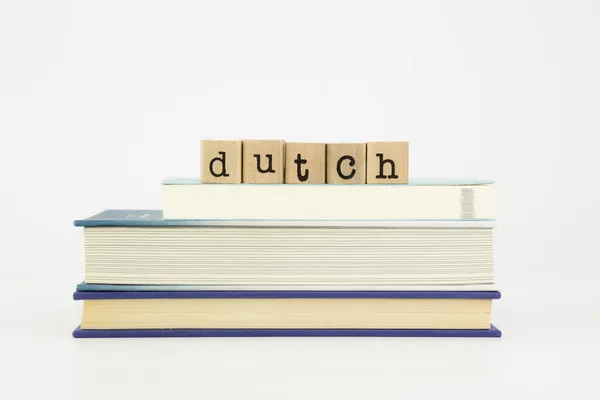 Dutch language word on wood stamps and books — Stock Photo, Image