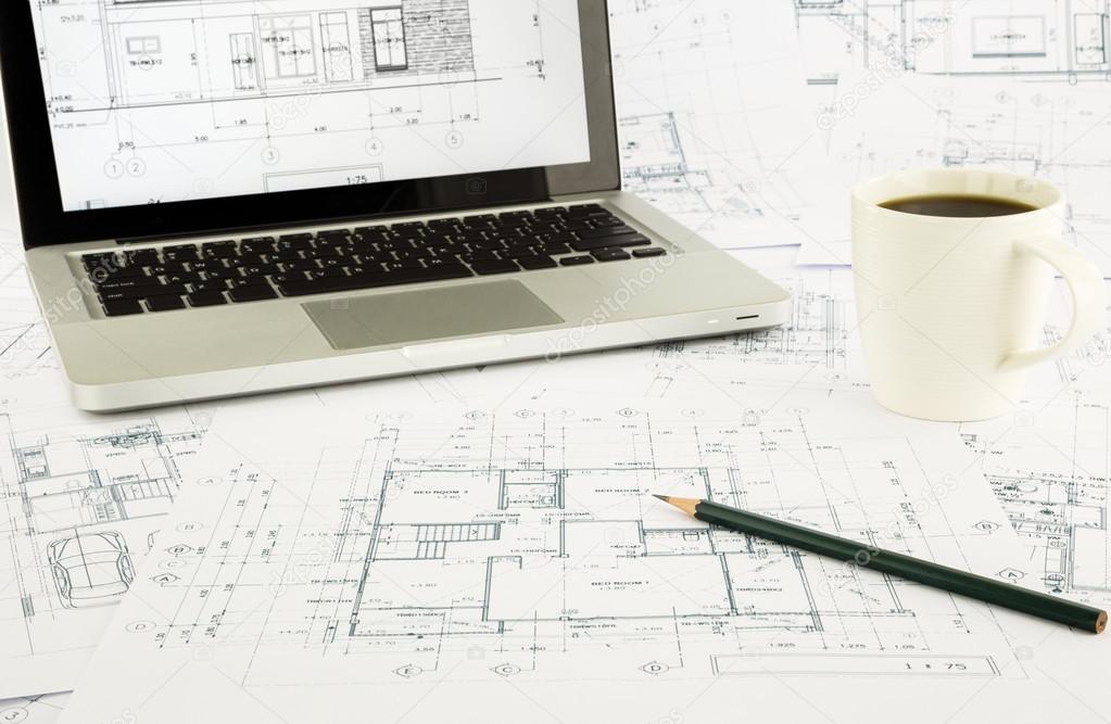 house blueprints and floor plan with laptop