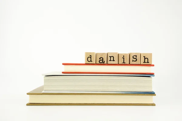 Danish language word on wood stamps and books — Stock Photo, Image