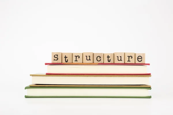Palabra de estructura sobre sellos y libros de madera —  Fotos de Stock