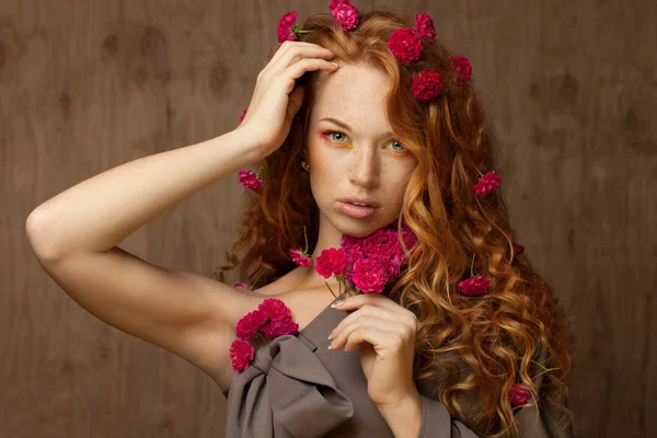 Red-haired girl in flowers — Stock Photo, Image