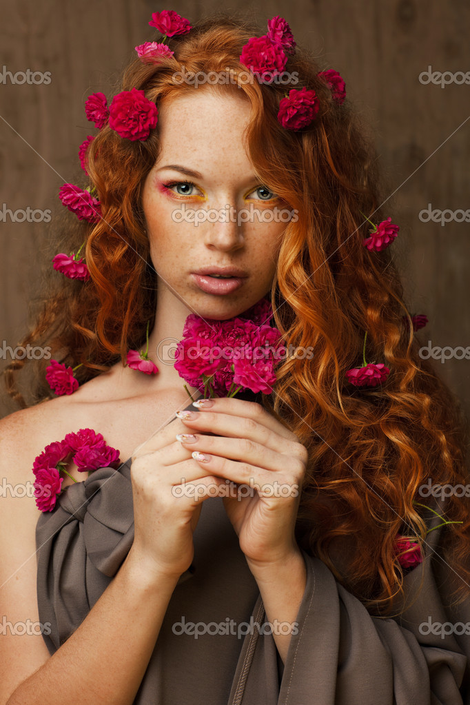 Redhaired girl in flowers Stock Photo by ©Svetlanamiku 30102317