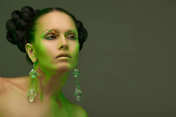 Austere beauty portrait in a green glow. — Stock Photo, Image