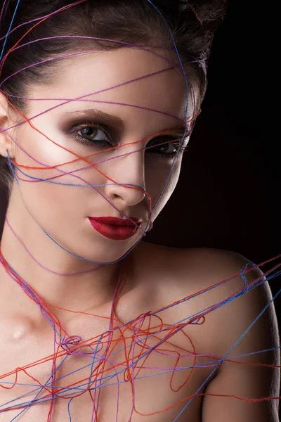 Girl in a web of threads. — Stockfoto